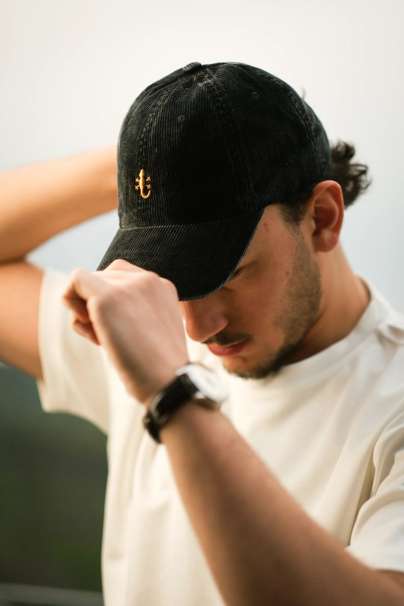 Man wearing a black embroidered cap
